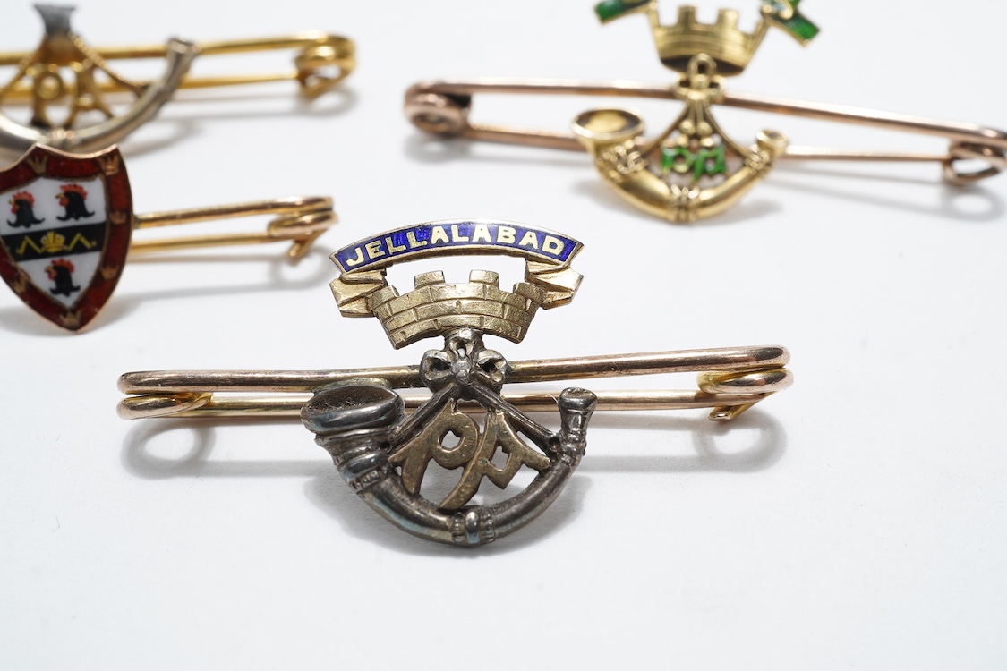 Four sweetheart type brooches; a hallmarked 9ct gold example with an enamel coat of arms, together with three yellow metal military brooches; all Prince Albert’s Somerset Light Infantry, two with enamelled ‘Jellalabad PA
